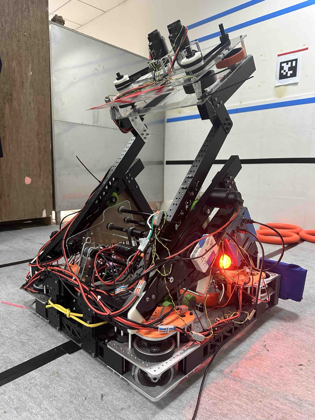 Competition robot with an angled shooter assembly raised above the chassis